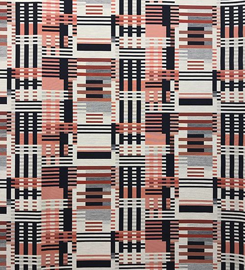Bauhaus-inspired textile with black and grey and orange geometric pattern. Designtex