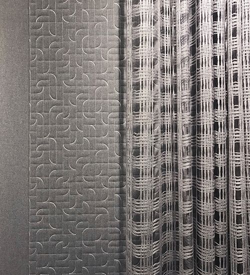 Three grey curtains transitioning from solid to subtle carving-like curves to loose weaves. Luum