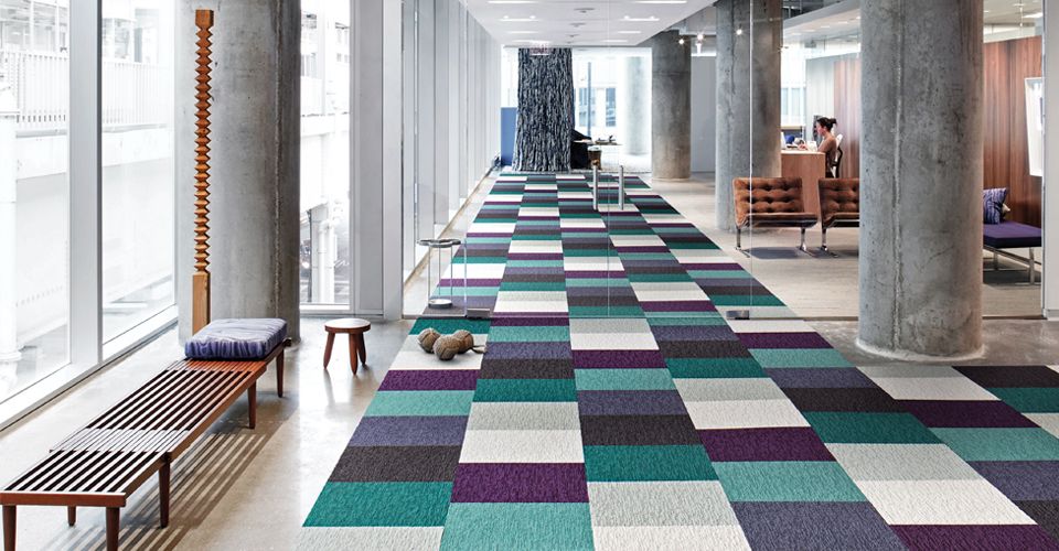 Office entry way with colorblocked carpet tile.