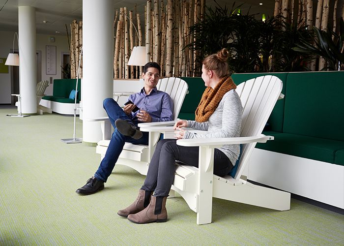 Two people speaking in an open, collaborative space in the Philips HQ in Hamburg, Germany.