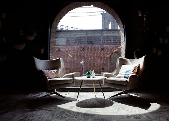 A secluded space at West Elm's HQ with plush armchairs and lots of natural light.