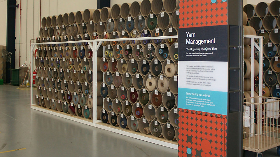 At the yarn management station visitors see cones of yarn stacked for use and learn how Interface efficiently manages yarn from purchase to recycling.