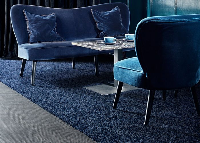 The use of darker shades to create a relaxing, cosy feel to the lounge area in a hotel. Products: Drawn Lines - Onyx, HN830 - Cobalt