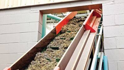 Reclaimed vinyl backing is shredded into small pieces and loaded into the agglomerator.